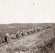 Buffalo Soldiers walking their bikes along railroad tracks, 1897 (National Archi