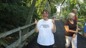 Advocate Kris Dyer celebrates the re-opening of the historic Riverside Bridge in