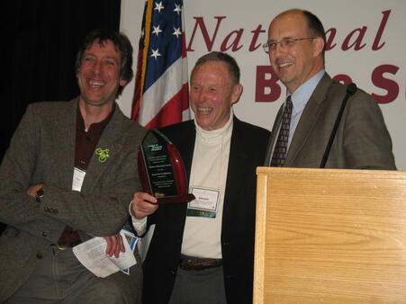 Mayor Hindman (center) and his son-in-law, Ian Thomas of Pednet, receives the first-ever National Outstanding Achievement Award from Andy Clarke of the League of American Bicyclists at the National Bike Summit in 2010 Mayor Hindman (center) and his son-in-law, Ian Thomas of Pednet